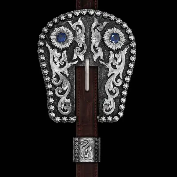 Our Paso Fino Headstall Buckle is inspired by our Iconic Calgary Custom 3-Piece Buckle Set. Hand crafted on a German Silver base, it feautres our signature berry edge, two flowers with your choice of cubic zirconia stone color, and detailed hand-engraved 